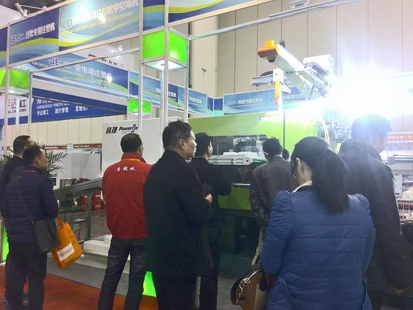 Customers look inside of Powerjet high speed injection molding machine